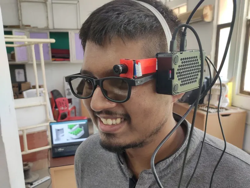 Mohit wearing a prototype computer-vision wearable built on eyeglasses