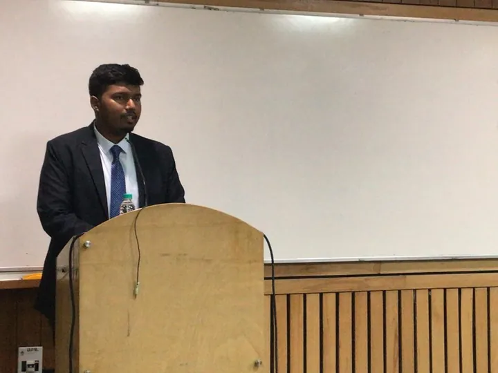 Mohit speaking at a podium during a student session at IIT Delhi